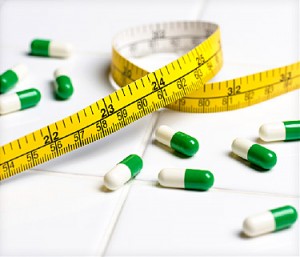 measuring tape and pills